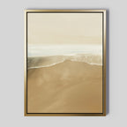 Sand and Sea Abstract Canvas Art features soft waves meeting a sandy shore in beige, white, and light brown tones, framed in gold for a minimalist style—creating serene shoreline artwork ideal for neutral home decor.
