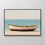 The Sandbound Vessel Canvas Art features an old white rowboat with rust stains on a sandy beach against calm blue water and a pale sky—ideal minimalist or coastal wall art for your bedroom decor.