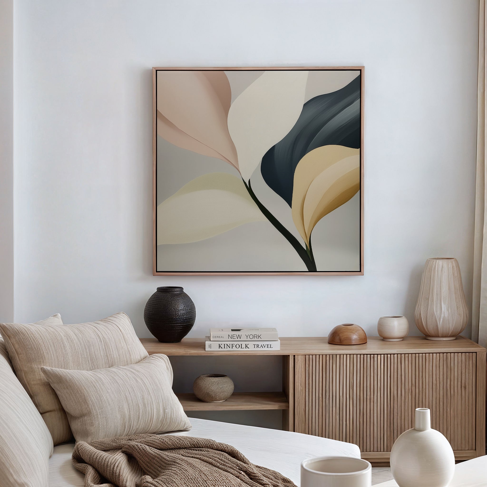 A modern living room featuring a beige sofa, neutral cushions, wooden sideboard, ceramic vases, books, and the Sculpted Elegance Canvas Art—a striking abstract botanical painting in soft earth tones—adds elegance to a white wall.