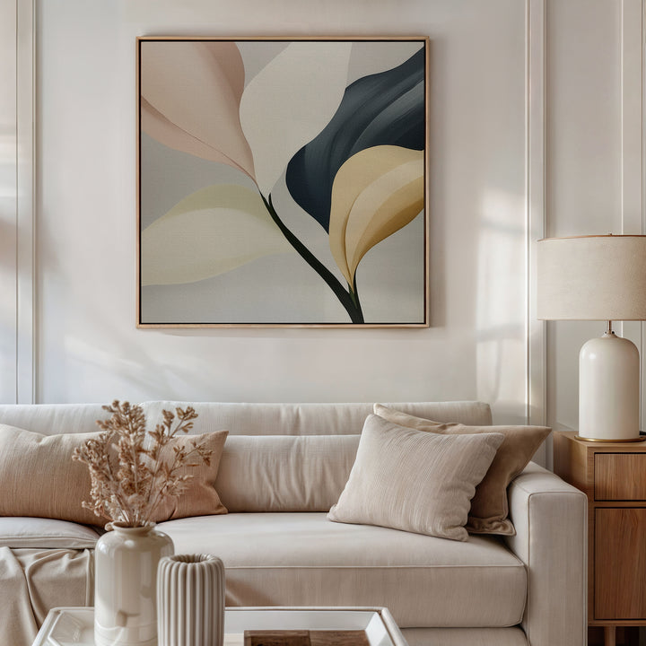 A modern living room with a beige sofa, neutral pillows, a lamp, and dried flowers features Sculpted Elegance Canvas Art—a minimalist botanical piece in muted tones—hung above the couch for an elegant décor accent.