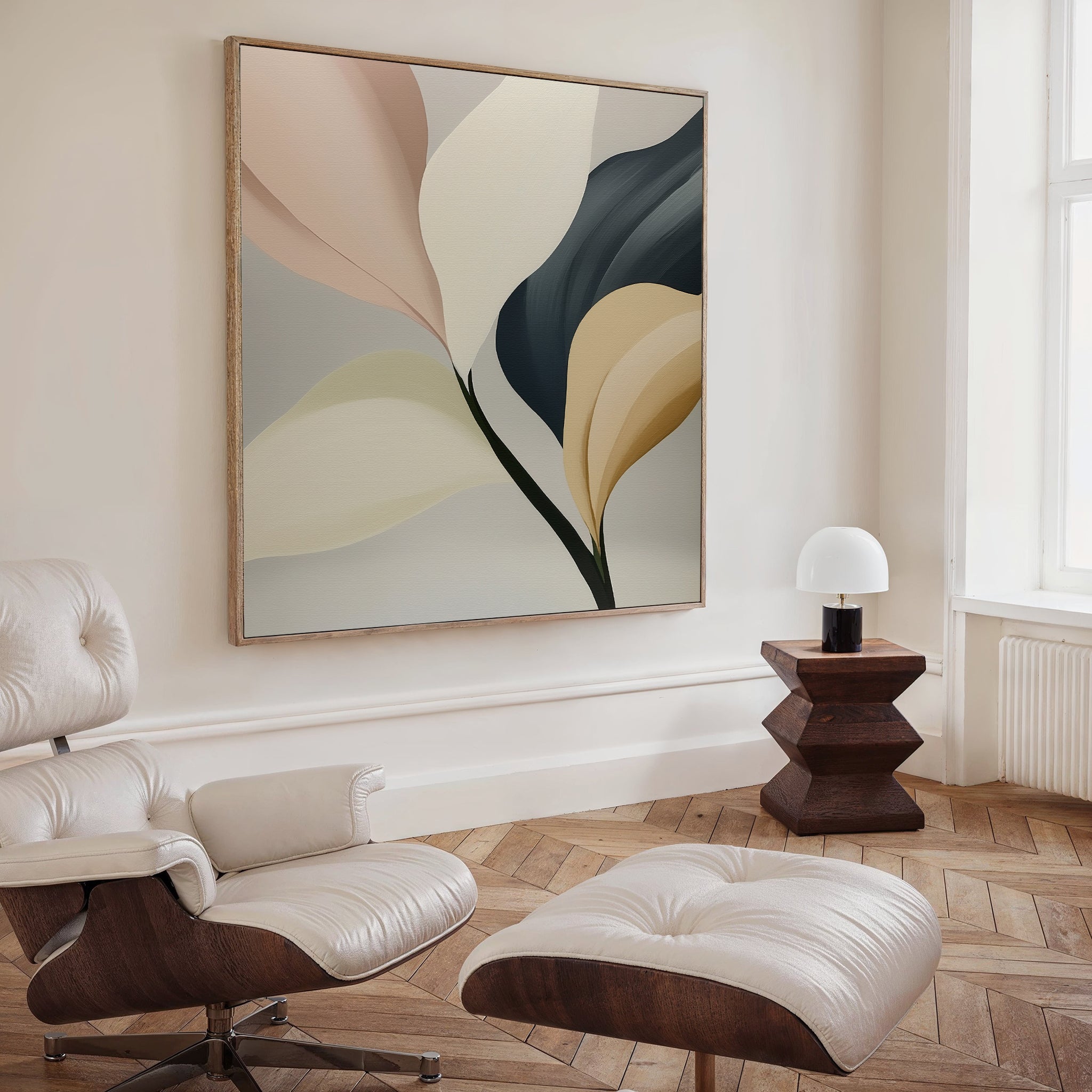 A modern living room features a cushioned lounge chair with ottoman, geometric wooden side table and lamp, plus the Sculpted Elegance Canvas Art. Wood floors and neutral walls finish this stylish decor.