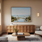 A cozy living room with light walls and neutral furniture features the Seaside Gaze Canvas Art above a wooden sideboard, while a coffee table with flowers in the center enhances the relaxing coastal wall art atmosphere.