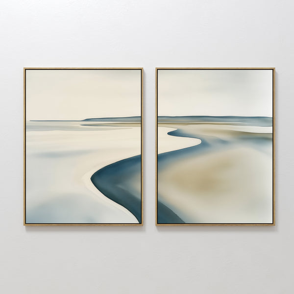 The Serene Coastline Set of 2 features abstract paintings with soft, blurred lines and muted tones of beige, blue, and gray, evoking water, sand, and sky—perfect minimalist wall art for creating a calm coastal vibe.