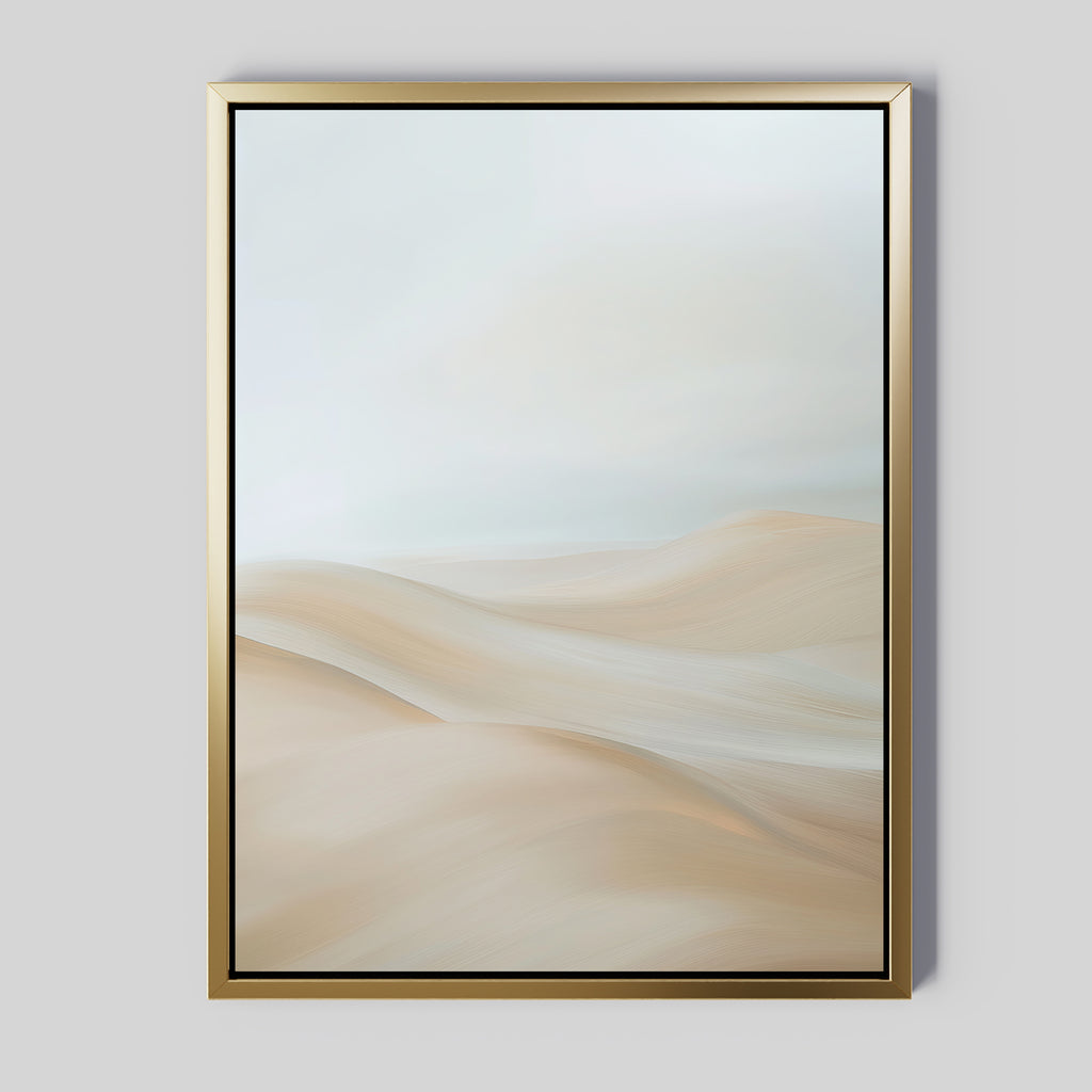 The Serene Peaks Abstract Canvas Art features a gold-framed painting of soft sand dunes in beige and cream beneath a pale, cloudy sky, creating a calm, minimalist landscape.