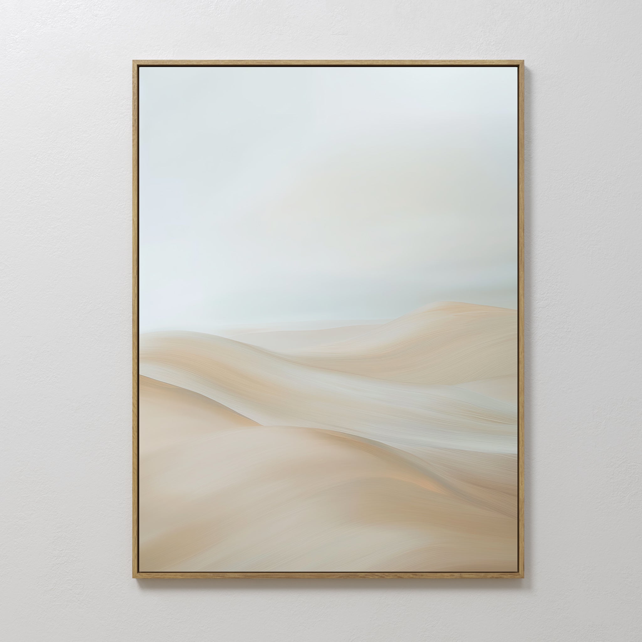 The Serene Peaks Abstract Canvas Art showcases soft, beige sand dunes beneath a pale, cloudy sky in a simple wooden frame. Its smooth lines and calming neutral colors make it perfect wall art for a tranquil space.