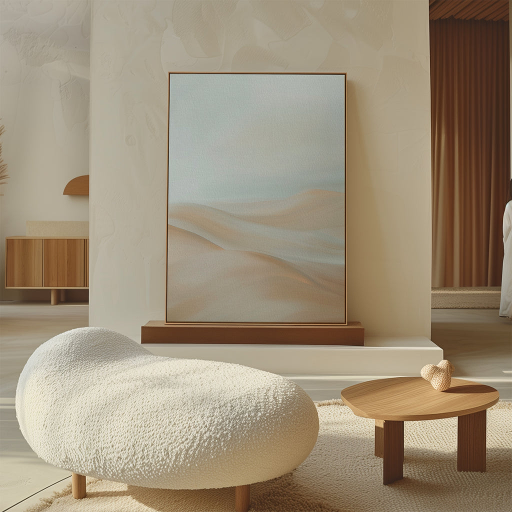 A modern, minimalist living room with a textured white lounge chair, a small wooden coffee table, and Serene Peaks Abstract Canvas Art framed against a neutral, sculpted wall.