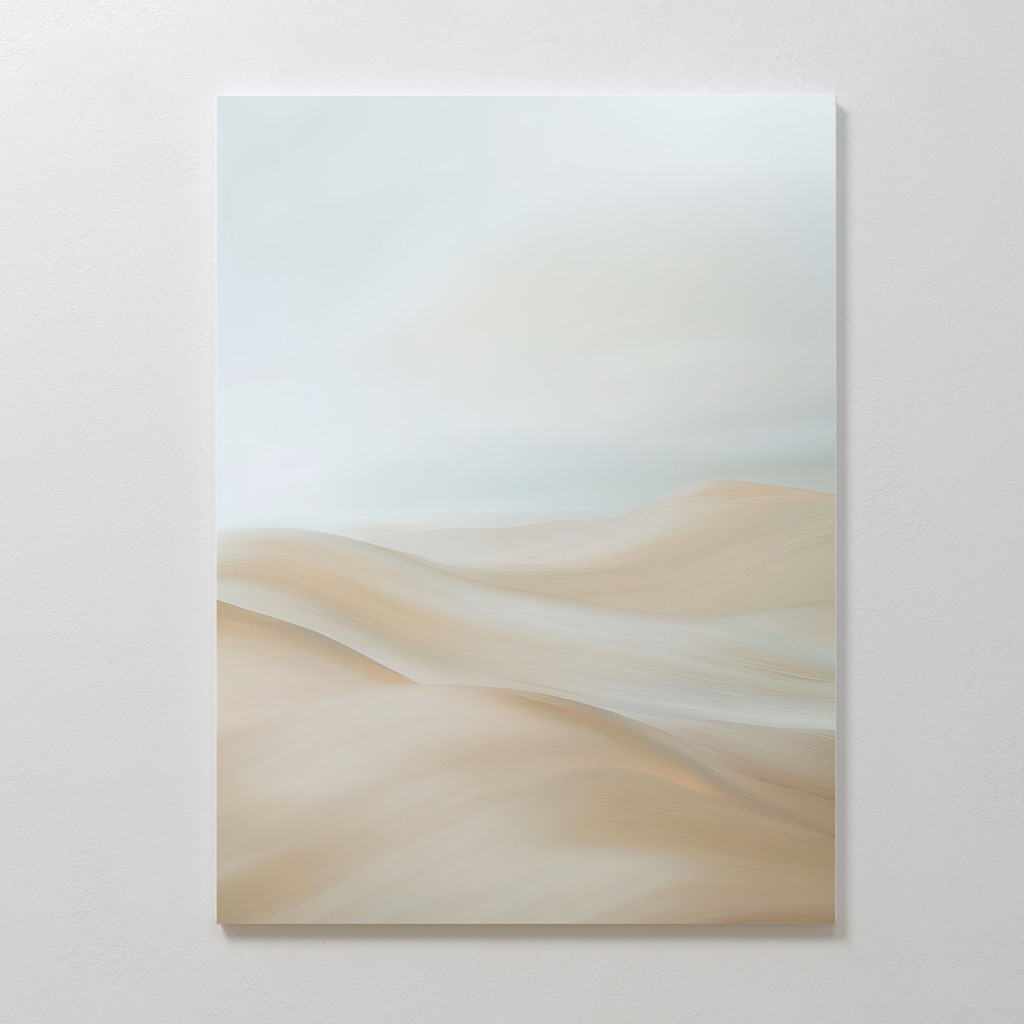 The Serene Peaks Abstract Canvas Art showcases soft, blurred beige and cream tones reminiscent of gentle sand dunes beneath a pale sky, creating a minimalist look when displayed on a plain white wall.