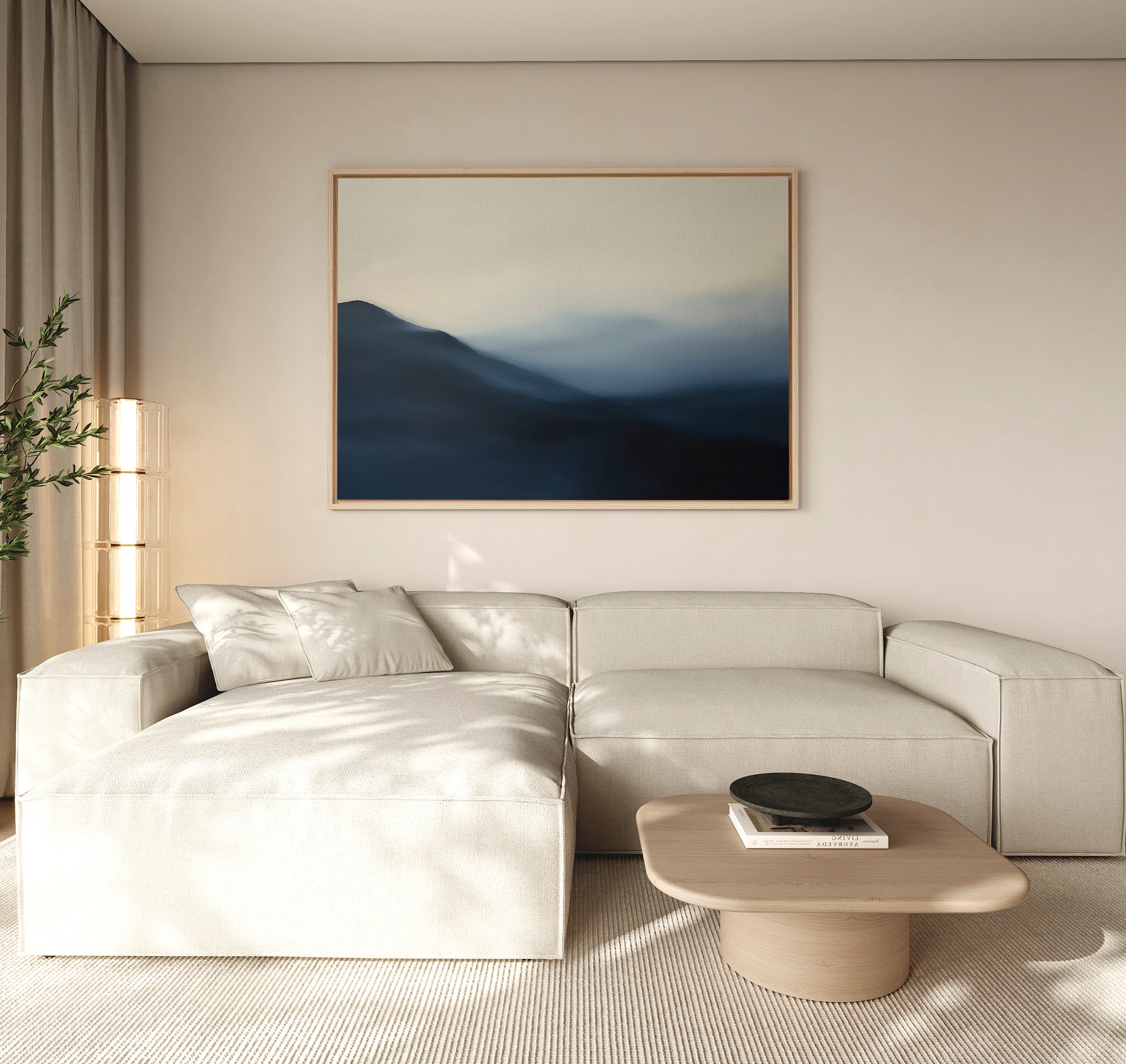 A modern living room with a beige sectional, light wood coffee table, minimal floor lamp, and the Shadowed Valley Canvas Art – Horizontal. Neutral tones and soft natural light create a serene, minimalist atmosphere.