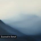 Shadowed Valley Canvas Art features soft, blurred blue and gray mountain shapes merging into a pale sky. This smooth abstract piece, labeled Zoomed-In Detail, is ideal for bedroom decor or anyone who loves minimalist wall art.