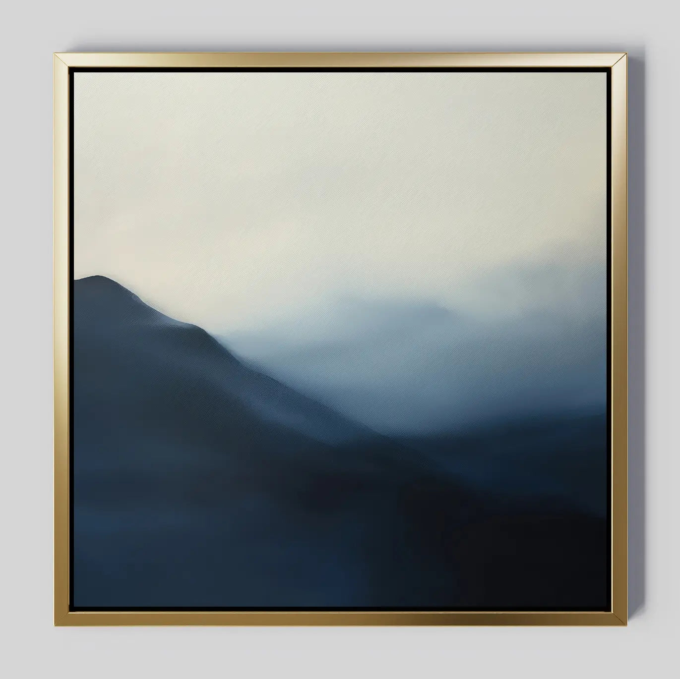 Shadowed Valley Canvas Art features abstract misty blue mountains fading into a foggy sky. Soft edges create a tranquil, minimalist landscape, while the simple metallic gold frame adds elegance—perfect for calming décor.