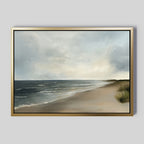 Shoreline Calm Canvas Art features a framed painting of a serene beach with gentle waves, grassy dunes, and birds in a cloudy sky—ideal coastal decor and the perfect beach wall art for your home.