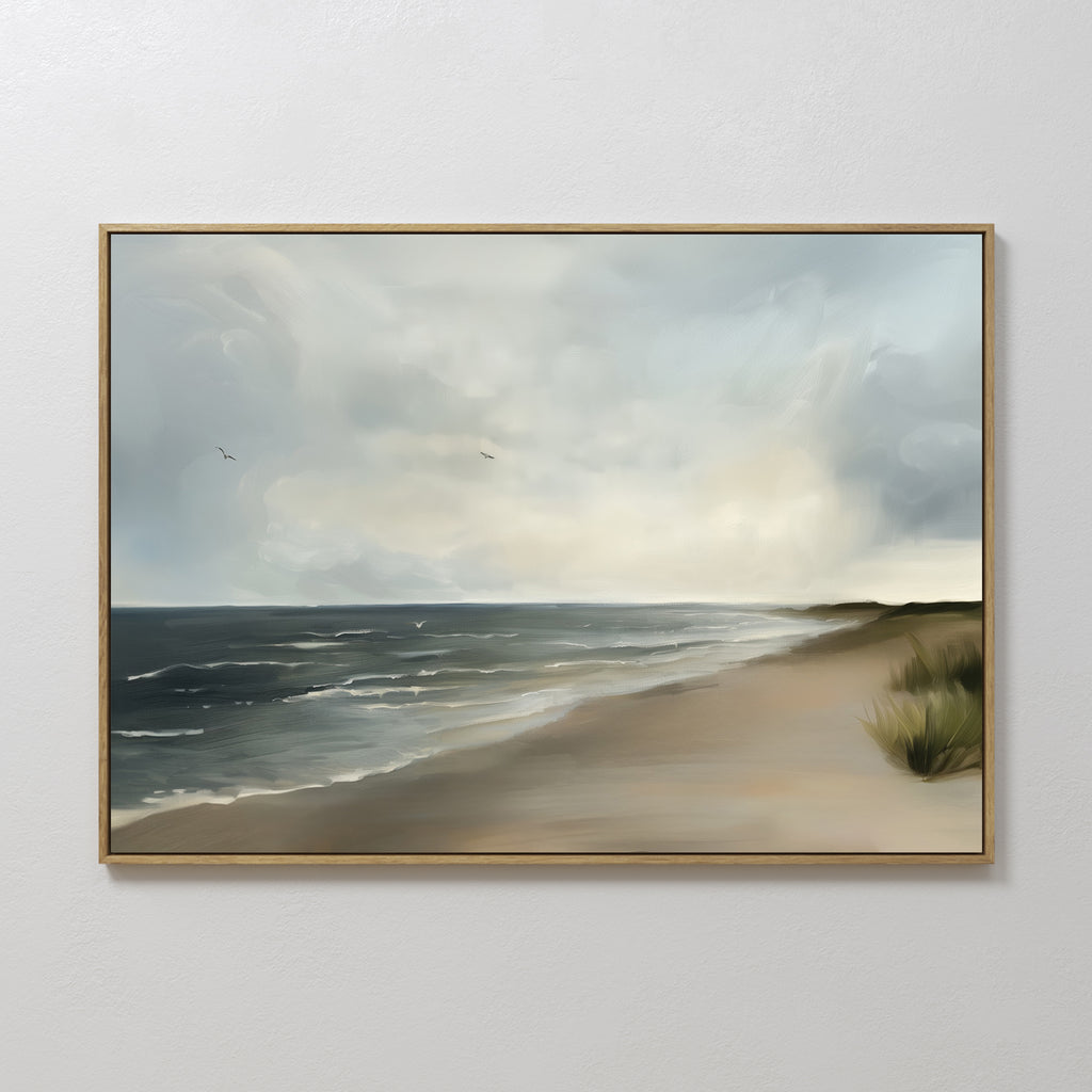 Shoreline Calm Canvas Art features a serene beach with gentle waves, cloudy sky, distant birds, and grassy dunes—perfect for enhancing your coastal decor as relaxing beach wall art.