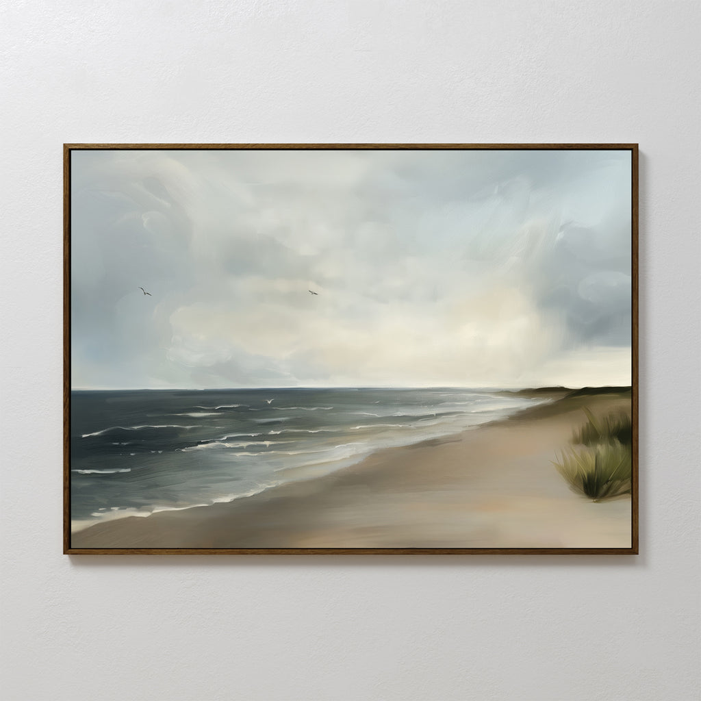 The Shoreline Calm Canvas Art features a framed painting of gentle waves, a cloudy sky, distant seagulls, and a sandy shore bordered by grass—perfect serene beach wall art and coastal decor for any space.