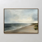 The Shoreline Calm Canvas Art features a framed painting of gentle waves, a cloudy sky, distant seagulls, and a sandy shore bordered by grass—perfect serene beach wall art and coastal decor for any space.