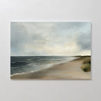 Shoreline Calm Canvas Art captures a peaceful beach with gentle waves, dune grass, and two birds in a gray-blue sky—ideal wall décor for enhancing any coastal-themed space.