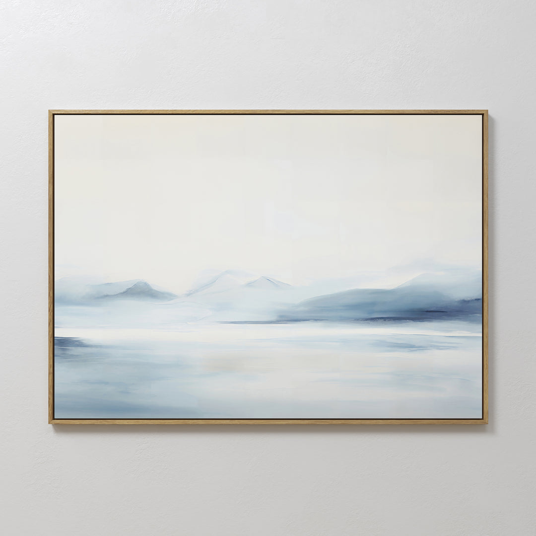 Silent Glaciers Canvas Art is a large framed abstract painting featuring misty blue and white tones that evoke distant mountains, adding minimalist serenity to any room.