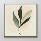 Silent Leaf Canvas Art showcases a green leafy branch on a light beige background in a sleek black frame. Its minimalist design and calming hues make it ideal for Nordic-inspired wall decor.