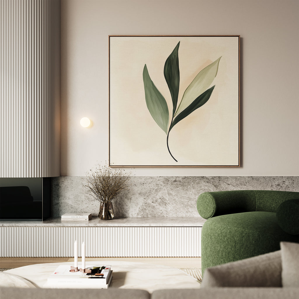 Modern living room with a large green armchair, marble shelf, and minimalist décor. Nordic wall features Silent Leaf Canvas Art—a framed botanical print with three green leaves above a vase of dried branches.
