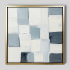 Silent Squares Abstract Canvas Art showcases overlapping rectangular blocks in white, gray, and light blue with a thin gold frame. Textured brushstrokes create a minimalist look, making it perfect wall art for modern home decor.