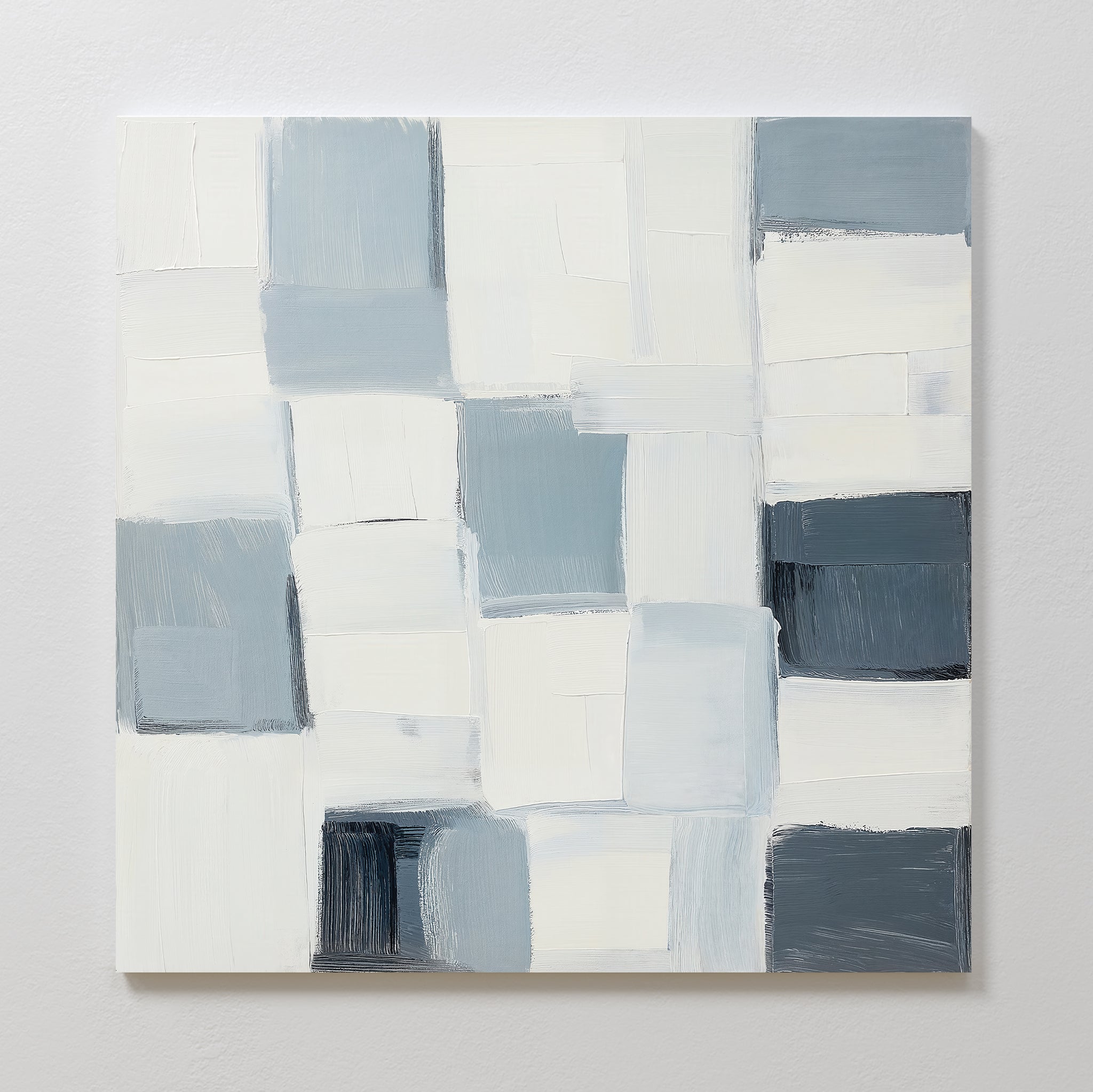 Silent Squares Abstract Canvas Art showcases overlapping white, gray, and blue rectangles with soft edges and visible brushstrokes—perfect minimalist wall decor for modern homes, shown mounted on a light-colored wall.