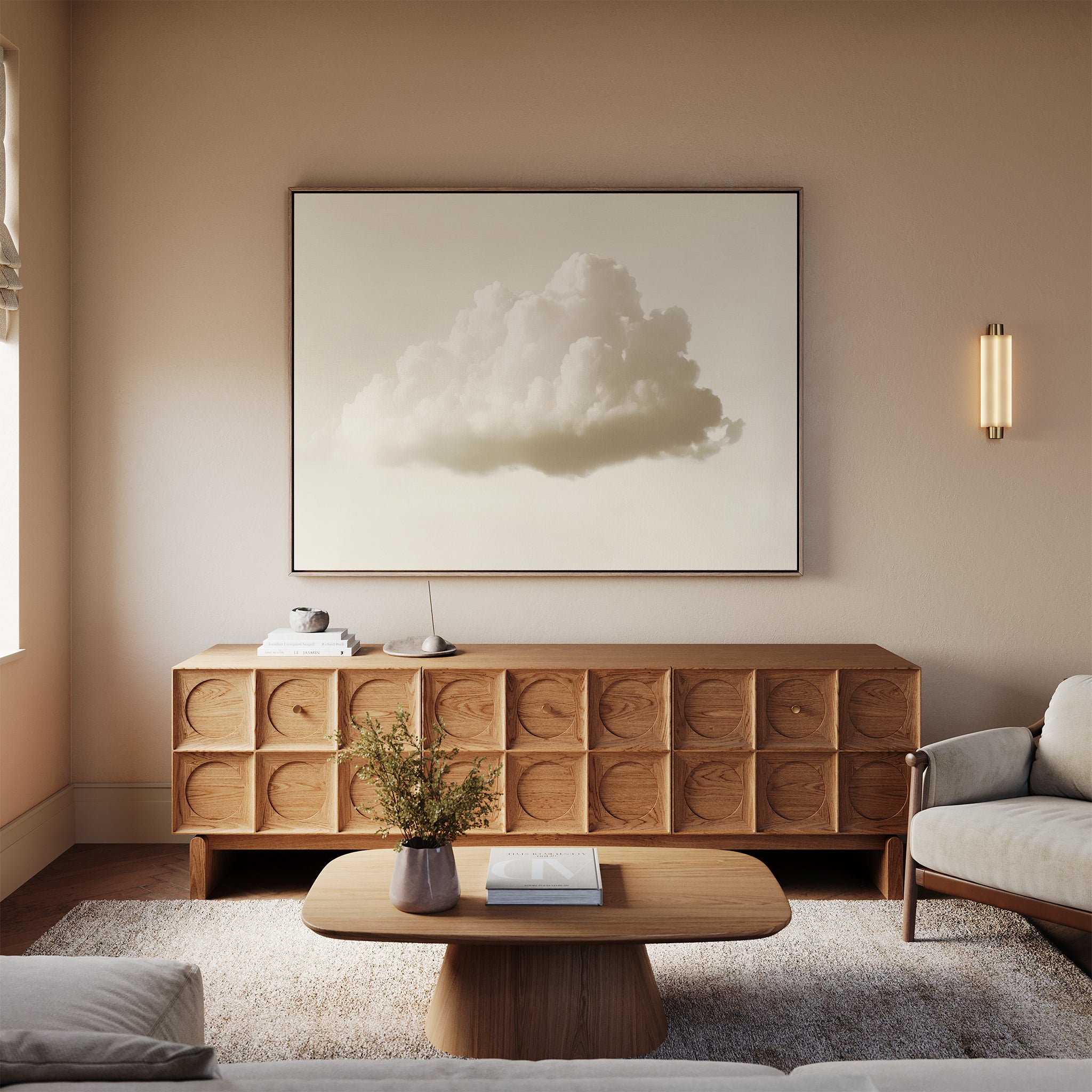A minimalist living room with a wooden sideboard, the Singular Vapor Canvas Art – Horizontal above it, a round coffee table with a vase and book, a light-colored sofa, and soft lighting against beige walls.