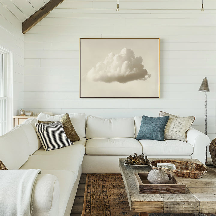 Bright living room with white shiplap walls, an L-shaped white sofa with assorted cushions, a rustic wooden coffee table, and the Singular Vapor Canvas Art – Horizontal above the couch. Natural light highlights the modern interiors.