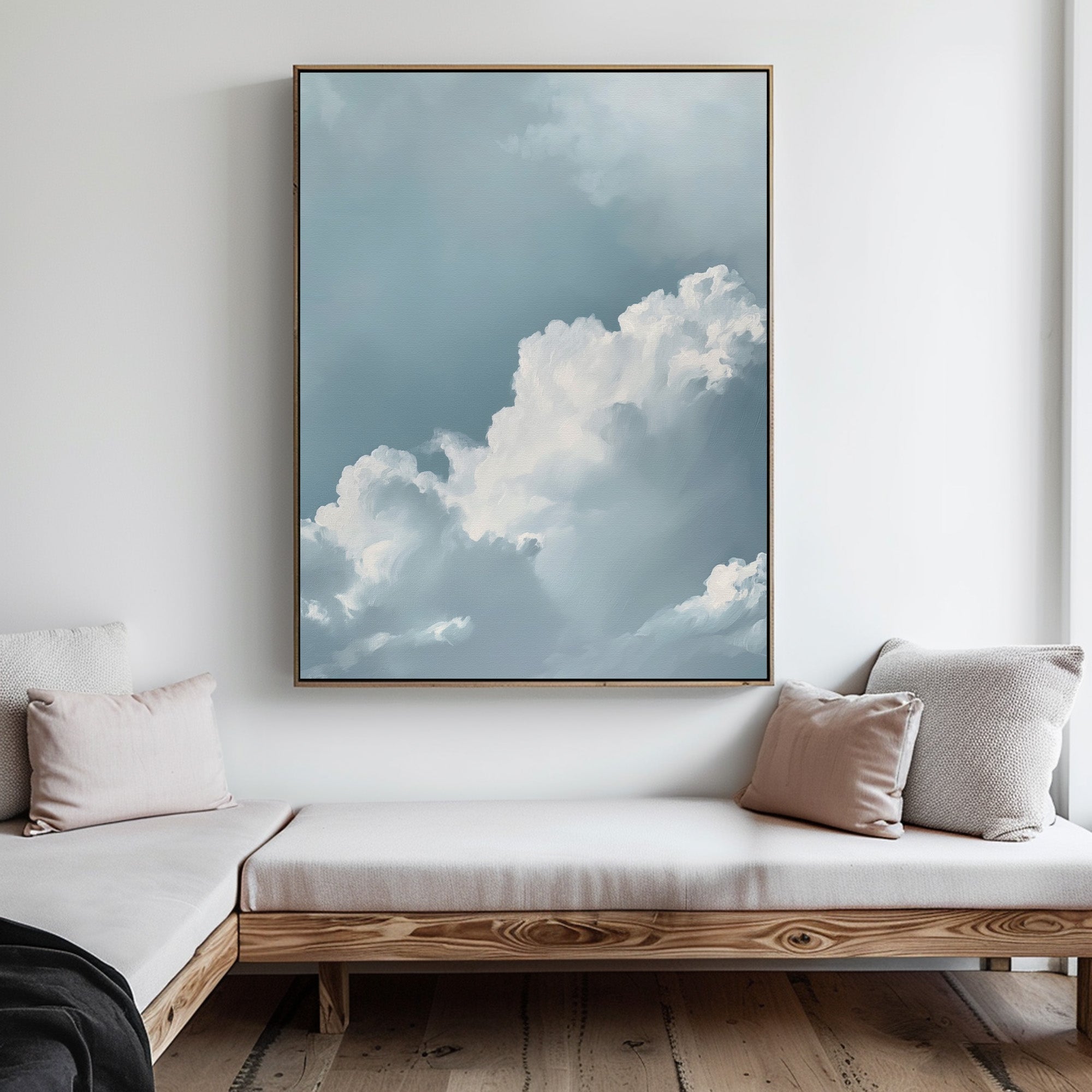 The Sky Serenade Abstract Canvas Art, featuring soft clouds against a blue sky, hangs above a wooden bench with light cushions and throw pillows, bringing a serene touch to this modern living room decor.