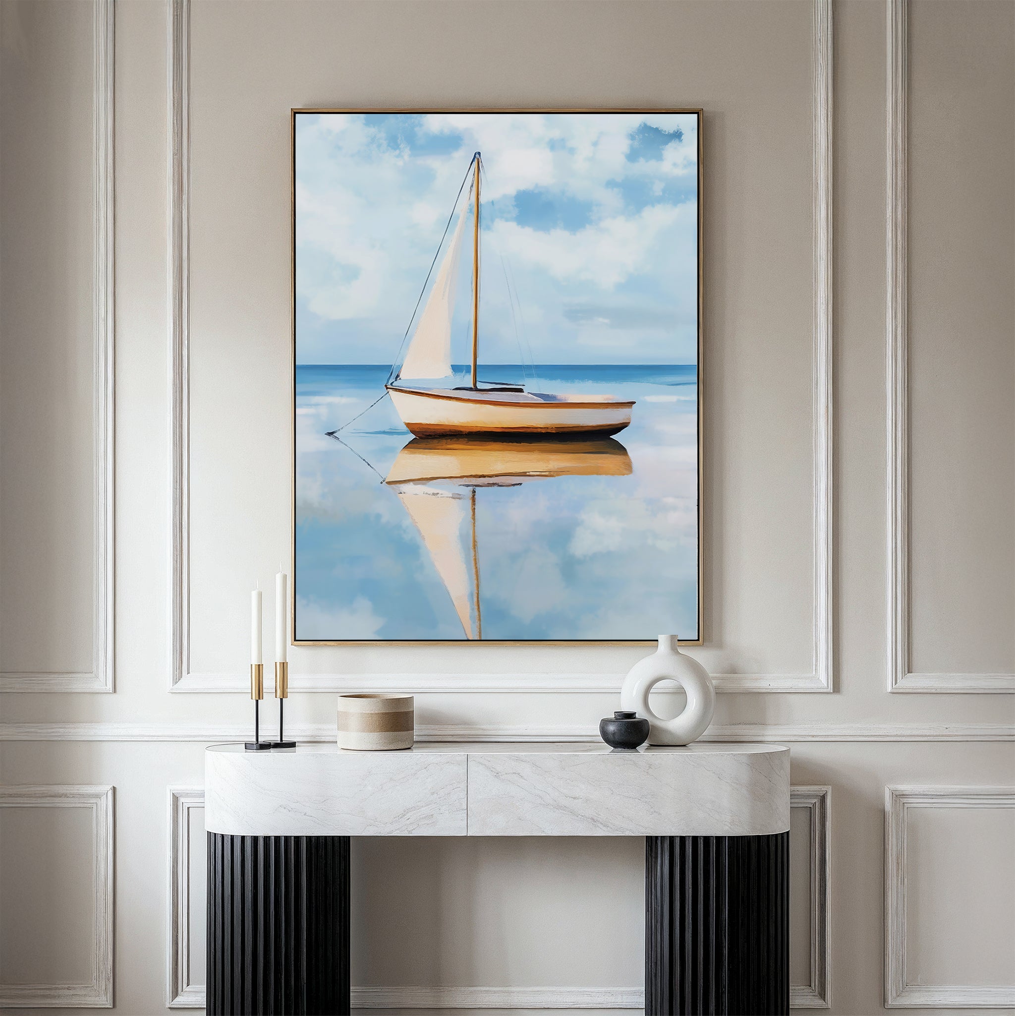 A modern, elegant room features a marble console table with minimal decor and Skybound Reflection Canvas Art above it—a sailboat mirrored on calm water under a blue sky—ideal for sophisticated bedroom decor.