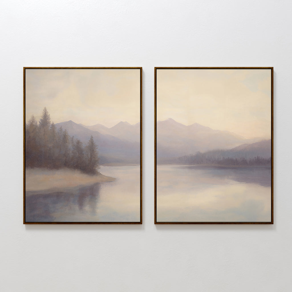 The Smoky Peaks Set of 2 features framed landscape prints of misty mountains and serene trees mirrored in a tranquil lake beneath a pale sky, elegantly displayed side by side on a white wall.