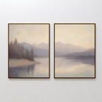 The Smoky Peaks Set of 2 features framed landscape prints of misty mountains and serene trees mirrored in a tranquil lake beneath a pale sky, elegantly displayed side by side on a white wall.