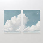 The Soaring Peace Set of 2 features wall art prints showing fluffy white clouds across a blue sky that flow seamlessly together, creating a calming focal point perfect for adding vintage charm to your space.