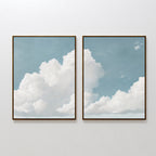 The Soaring Peace Set of 2 features framed wall art prints of fluffy white clouds against a blue sky, displayed side by side. This set creates a tranquil scene, ideal for adding a serene touch to your vintage decor.