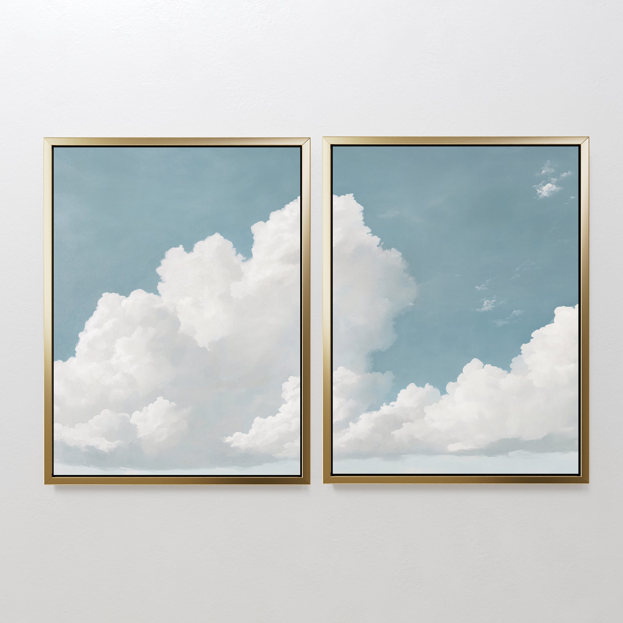 The Soaring Peace Set of 2 features framed prints of fluffy white clouds on a blue sky, hung side by side to create a tranquil, serene atmosphere on any plain wall.