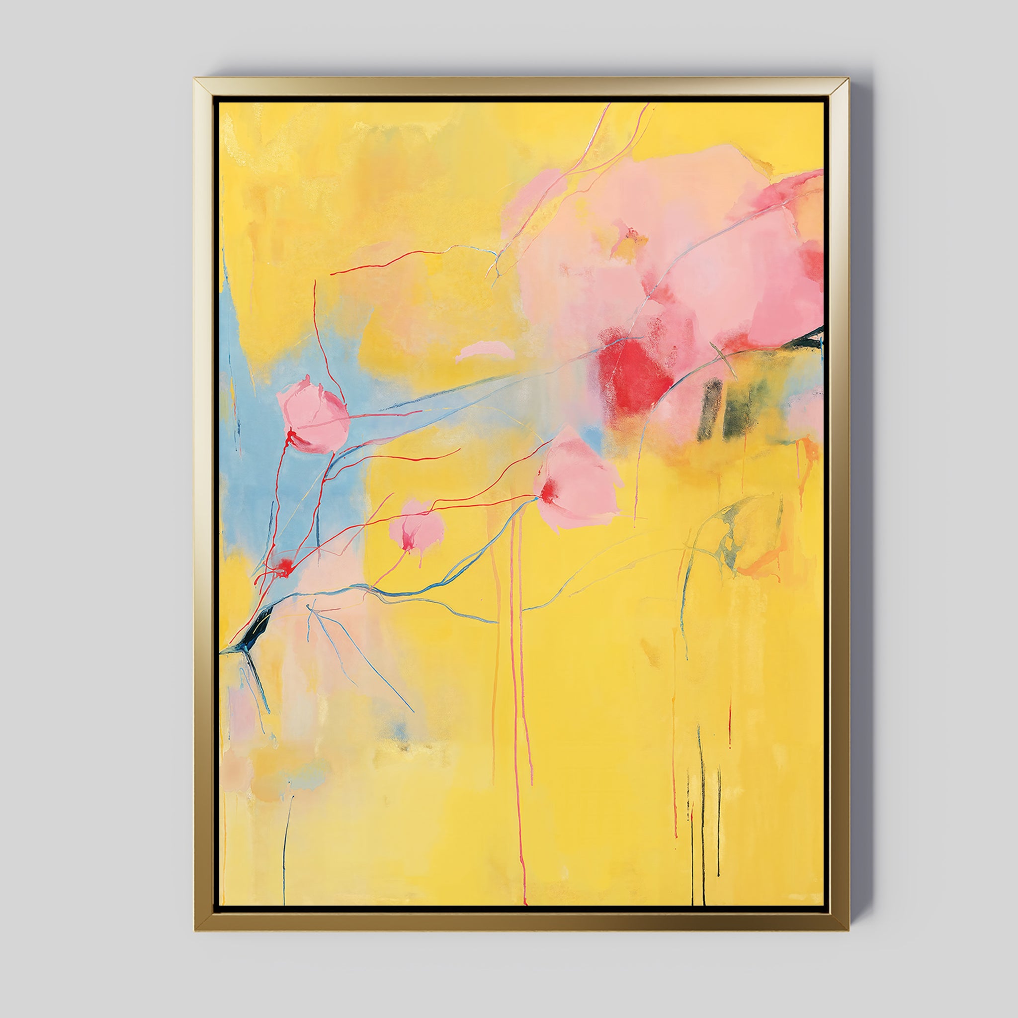 Soft Bloom Abstract Canvas Art features a yellow background with pink, red, and blue accents. Delicate shapes and fine lines create a floral, airy look. This vibrant wall art comes framed in gold—ideal for adding color to your living room decor.