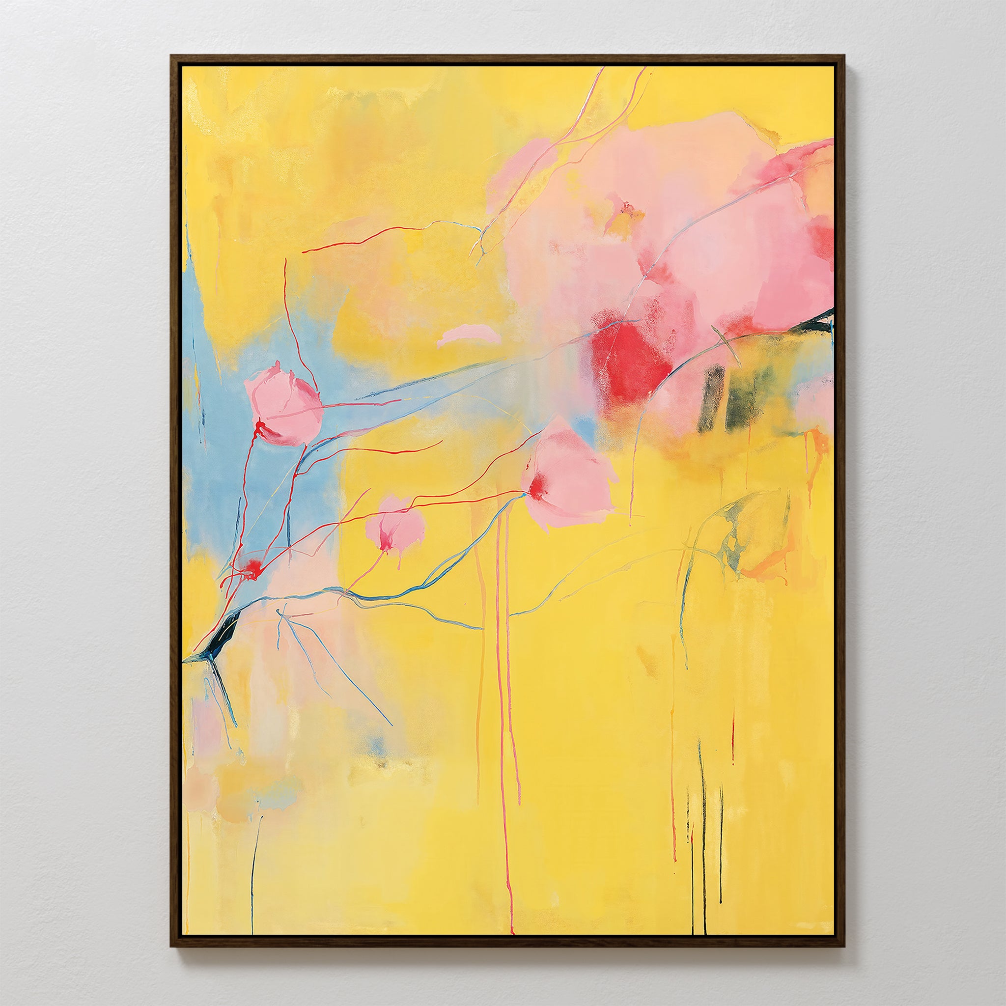 Soft Bloom Abstract Canvas Art features a bright yellow backdrop, light blue accents on the left, and connected pink and red blossom shapes. Framed and ready to hang, its a vibrant addition to any living room décor.