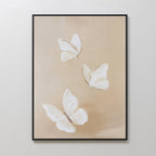 Linen Wings Canvas Art showcases three white butterflies with delicate wings on a soft beige backdrop—an elegant framed wall decor perfect for Nordic Park-inspired spaces.
