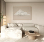 A minimalist living room with a light beige sectional, wooden coffee table, Soft Drift Canvas Art on the wall, and neutral decor bathed in soft natural light from the left, creating a serene space with subtle neutral tones throughout.
