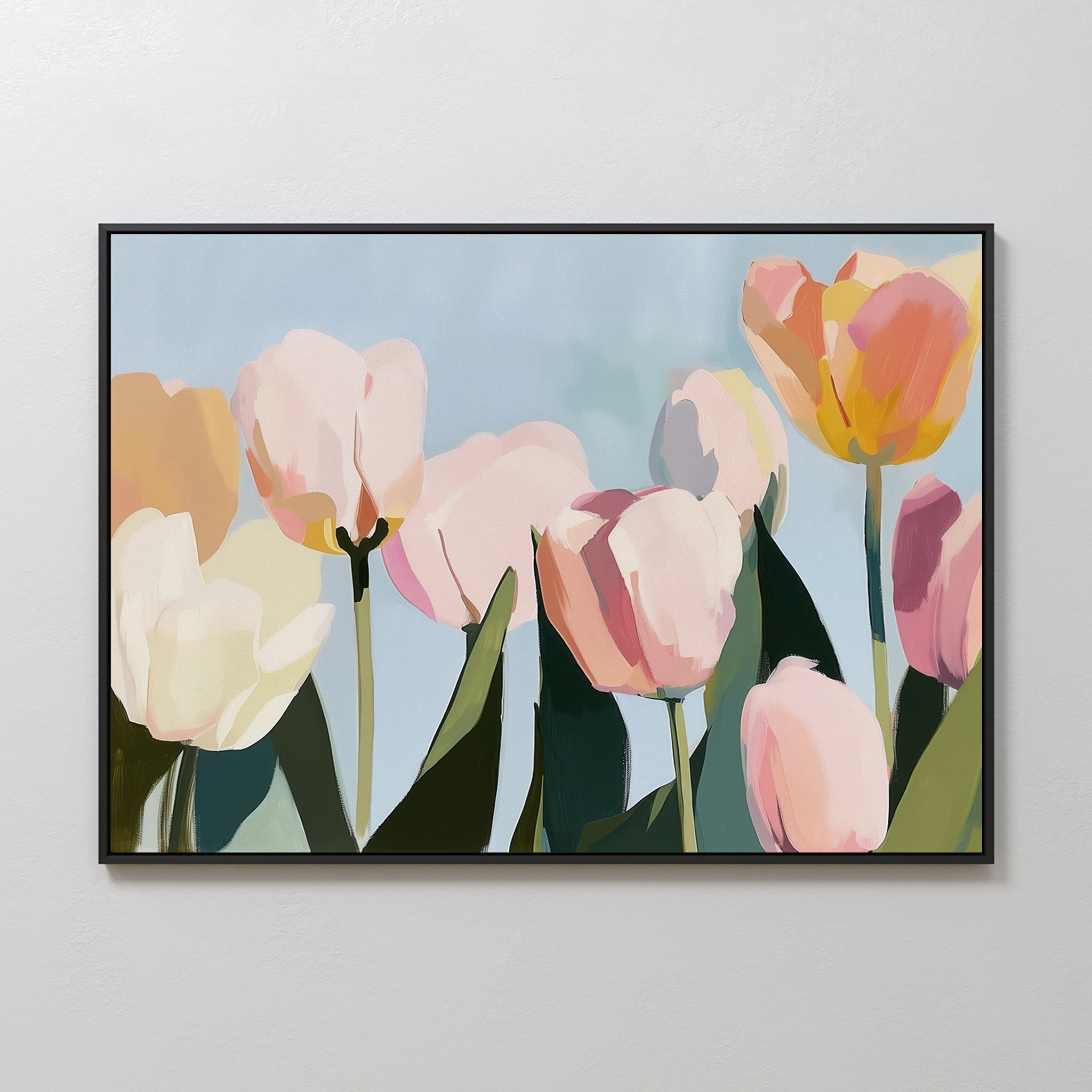 The Soft Field Canvas Art showcases tulips with pink, yellow, and white petals on a soft blue background. Designed in a modern, abstract style with green leaves, its the perfect minimalist wall art for any space.