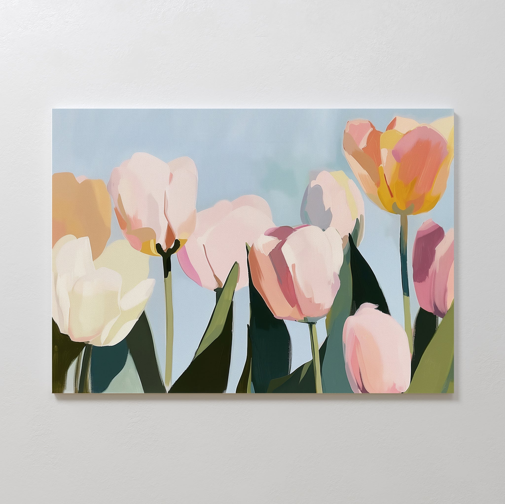 The Soft Field Canvas Art features pastel tulips with pink, yellow, and white petals on a soft blue background, adding a gentle, minimalist touch to any white wall.