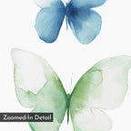 Soft Flight Canvas Art features two watercolor butterflies, one blue and one green, on a white background. The minimalist design includes a "Zoomed-In Detail" label in the lower left, partially overlapping the green butterfly’s wing.