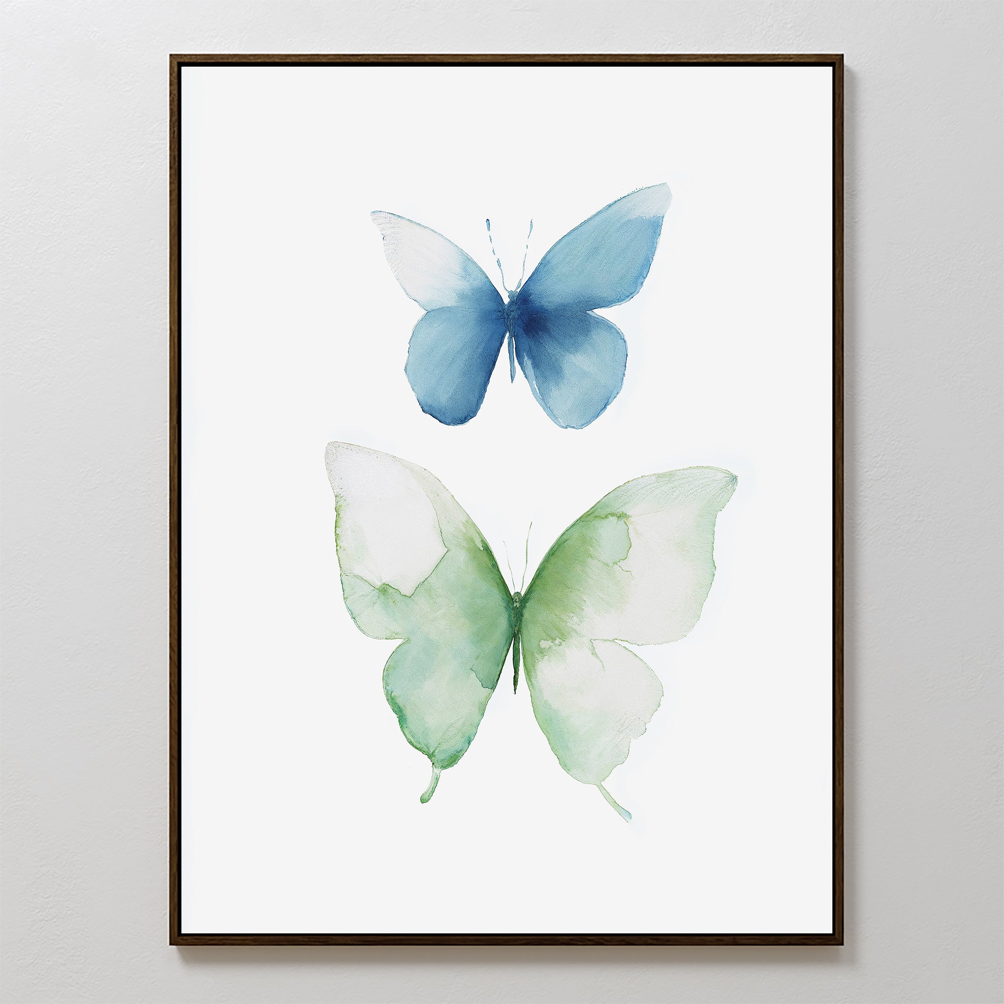 The Soft Flight Canvas Art is a framed minimalist wall decor featuring two watercolor butterflies—a blue one above and a larger green one below—on a clean white background.