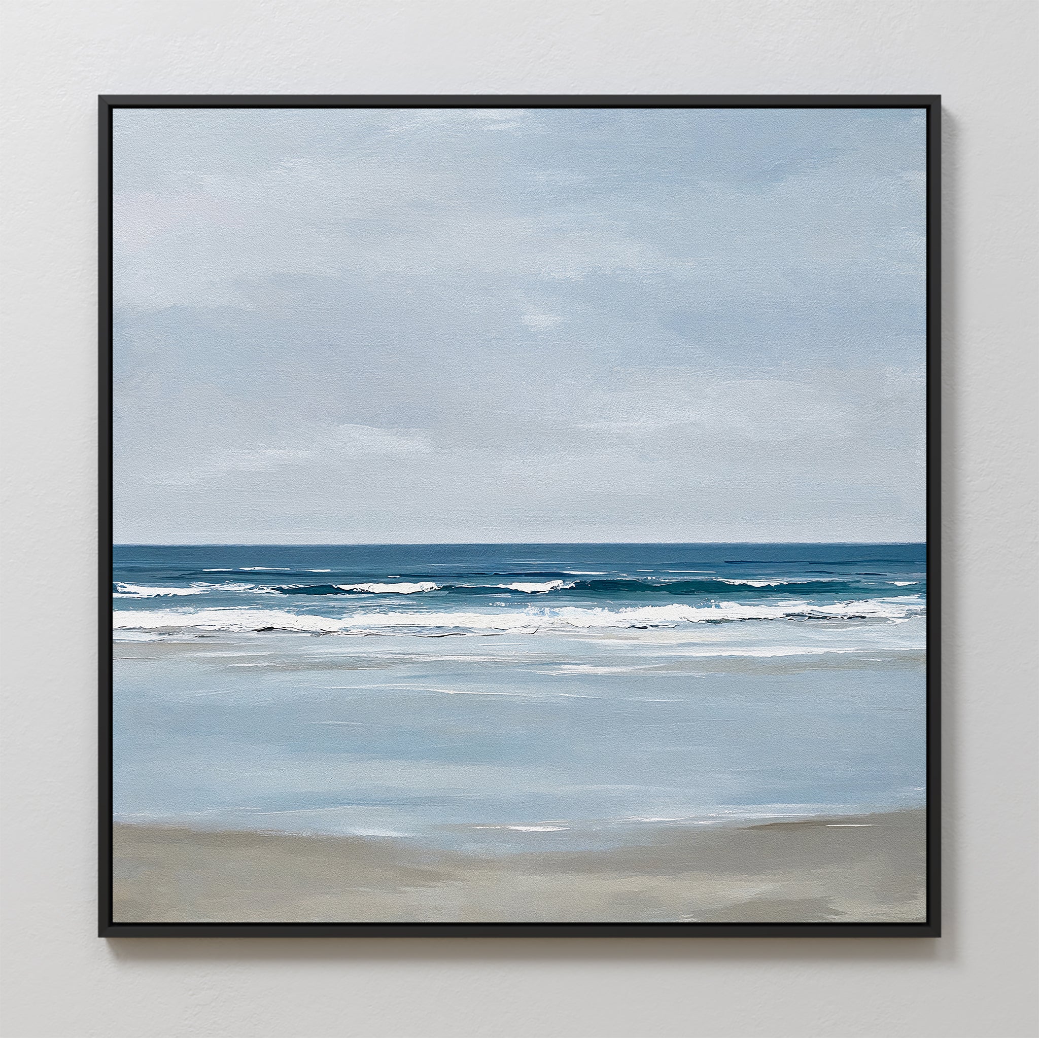 Soft Tide Canvas Art features a serene beach with gentle waves, light brown sand, and a cloudy blue-gray sky. This framed piece adds peaceful, minimalist coastal decor to your wall art collection.