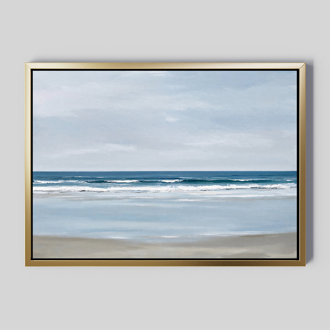 The Soft Tide Canvas Art – Horizontal features a calm beach with gentle waves and a muted blue and beige sky, set in a metallic gold frame. Ideal minimalist or coastal wall art to elevate your bedroom decor.