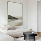 A modern living room with a cream-colored sectional, black round coffee table, and Soft Valley Canvas Art – Vertical. Minimalist decor and neutral tones create an elegant, timeless atmosphere.