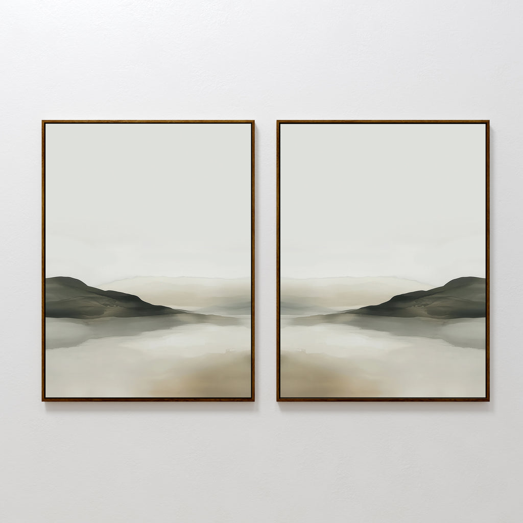 The Soft Valley Set of 2 features framed landscape wall art with muted green, gray, and beige tones depicting gentle hills and a hazy sky over water—an ideal, peaceful accent for minimalist decor on a plain white wall.