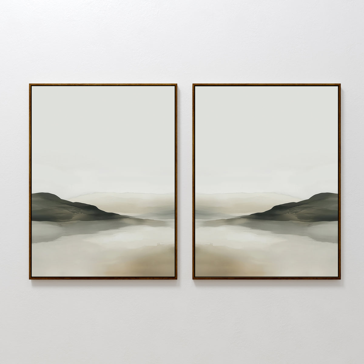 The Soft Valley Set of 2 features framed landscape wall art with muted green, gray, and beige tones depicting gentle hills and a hazy sky over water—an ideal, peaceful accent for minimalist decor on a plain white wall.