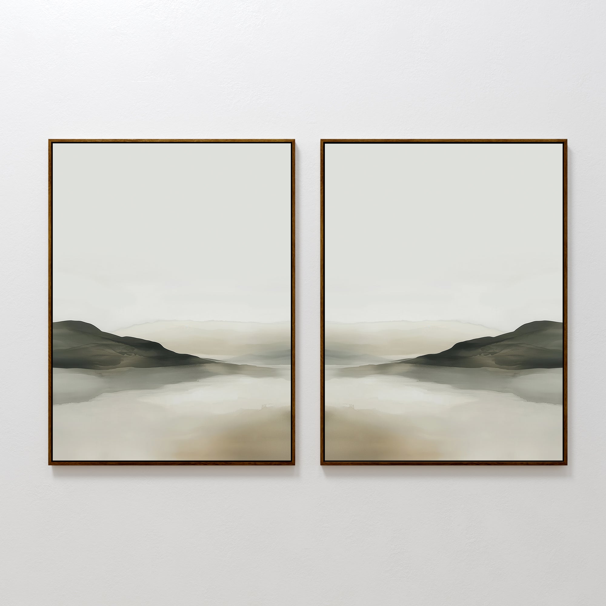 The Soft Valley Set of 2 features framed landscape wall art with muted green, gray, and beige tones depicting gentle hills and a hazy sky over water—an ideal, peaceful accent for minimalist decor on a plain white wall.
