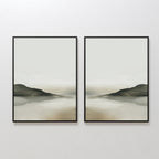 The Soft Valley Set of 2 features framed landscape wall art in muted earth tones, each showing misty hills and water with soft, blurred edges—ideal for bringing a peaceful touch to minimalist spaces.