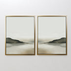 The Soft Valley Set of 2 features landscape wall art in gold frames, each showcasing gentle hills, misty neutral backgrounds, and water reflections—ideal for fans of peaceful, minimalist decor.