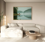 A modern, minimal living room with a light-colored sectional sofa, wooden coffee table, and the Solitude by the Lake Canvas Art, creating serene spaces with peaceful forest and water views.